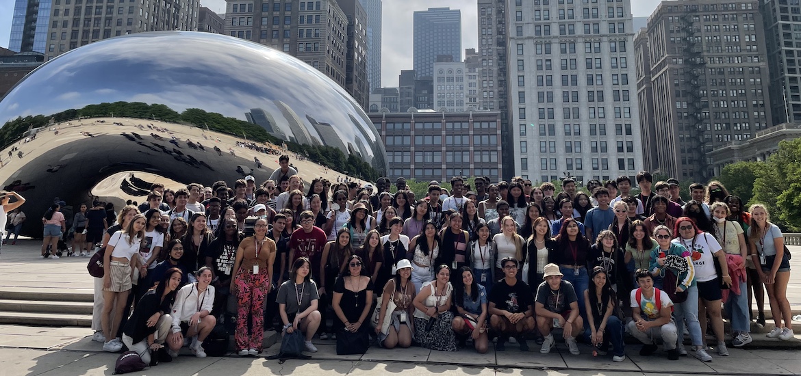 Students pose in front of Cloud Gate sculpture